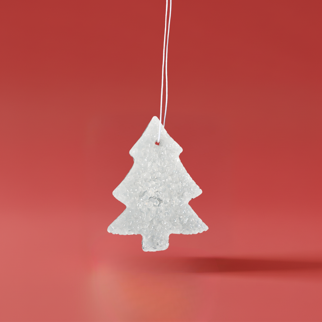 White holiday tree shaped scented aroma bead air freshener with clean fragrance on a red background