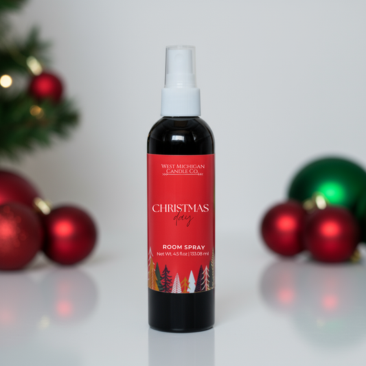 Christmas Day room spray with red label, a clean plant-based holiday home fragrance displayed with ornaments