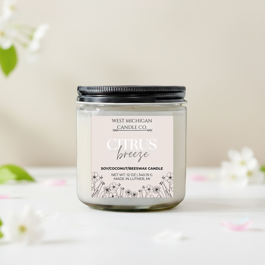 Citrus spring candle with floral design on label against a light background