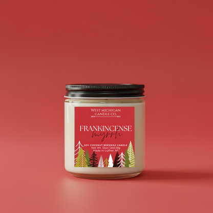 Frankincense Myrrh candle with a red label featuring trees on a red background