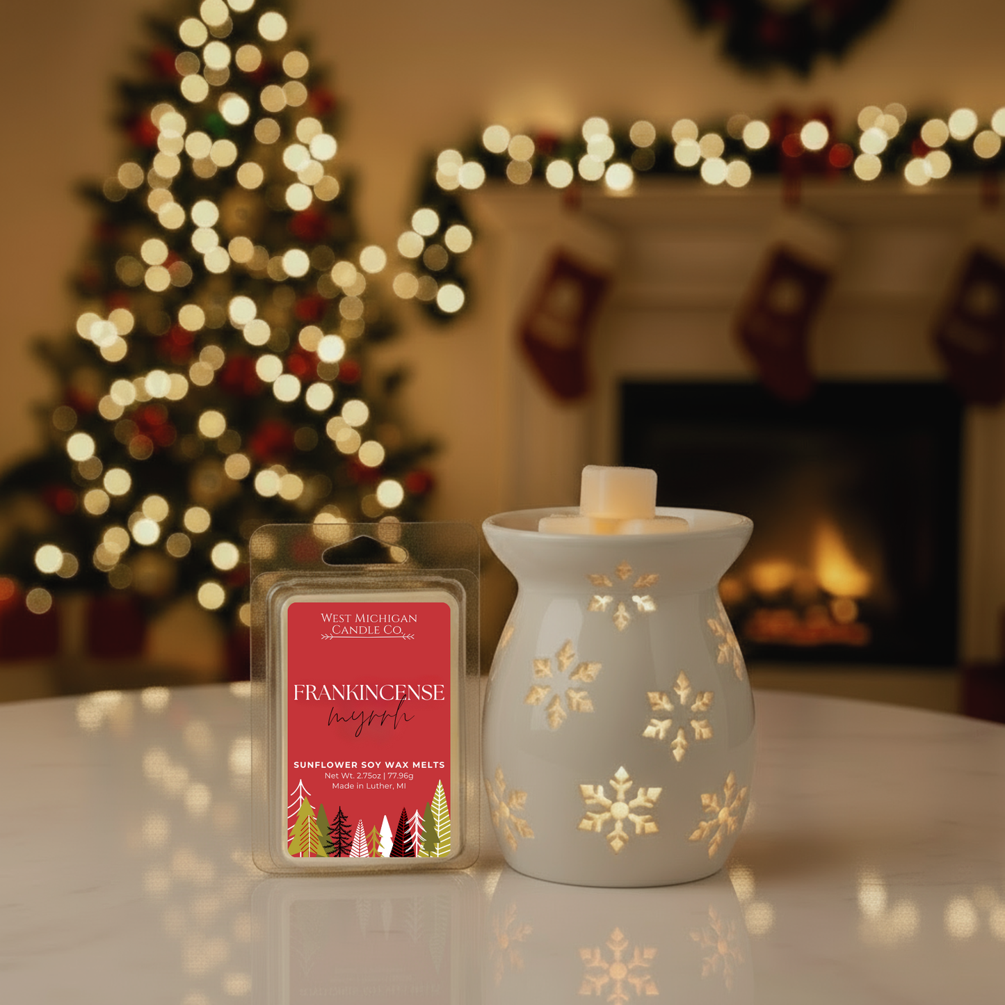 West Michigan Candle Co. Frankincense & Myrrh wax melt and warmer with Christmas tree and fireplace in the background